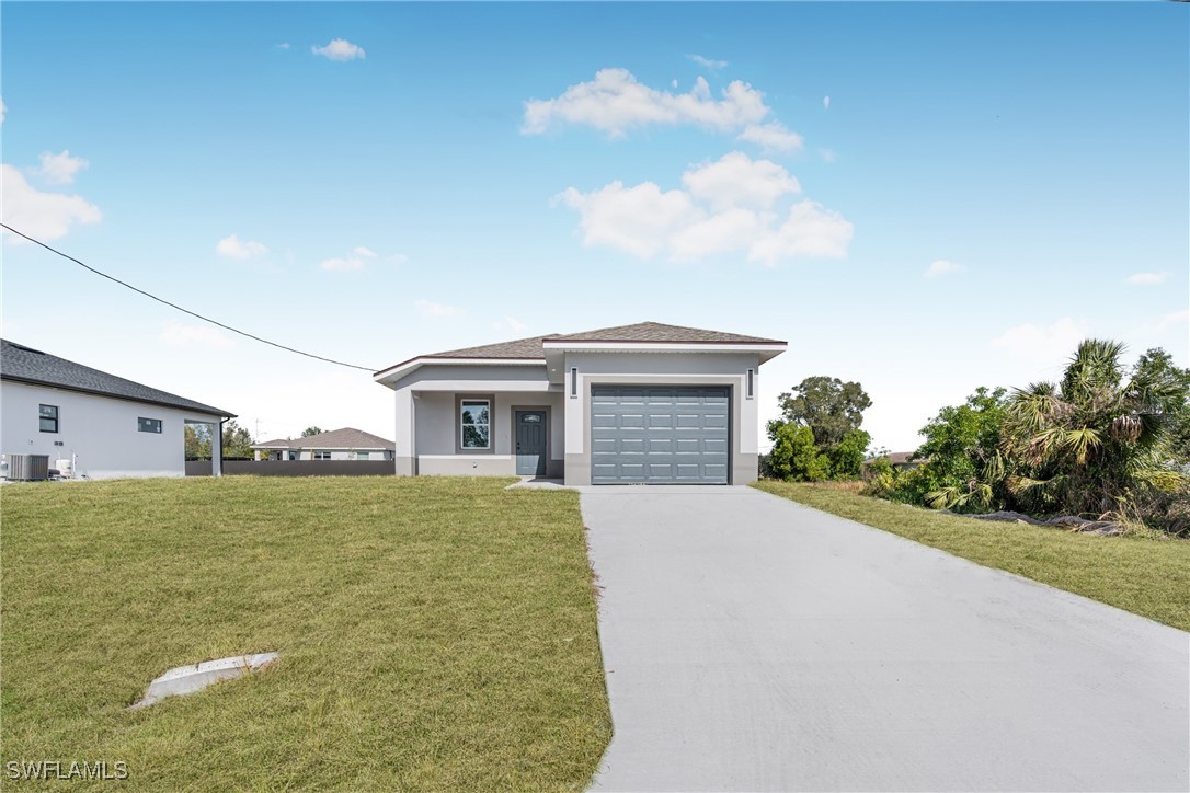 3604 26th Street Southwest Lehigh Acres, FL 33976 - Photo 4 of 38 a view of a house with a big yard