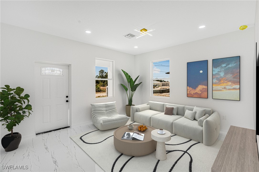 3604 26th Street Southwest Lehigh Acres, FL 33976 - Photo 5 of 38 a living room with furniture and flowers