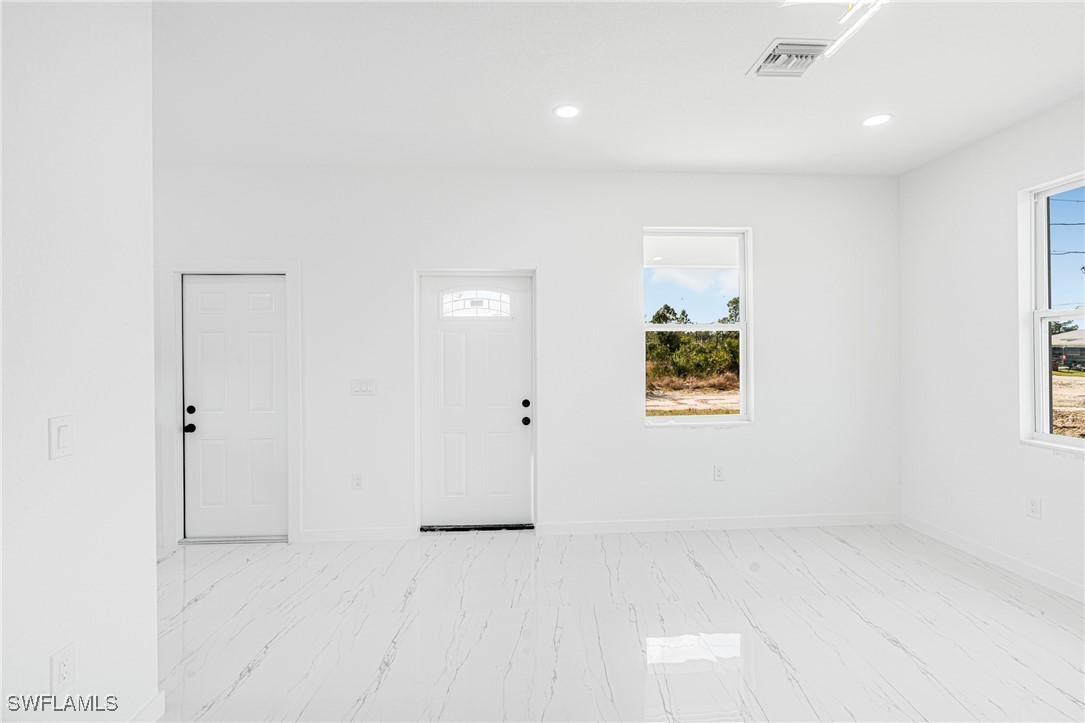 3604 26th Street Southwest Lehigh Acres, FL 33976 - Photo 6 of 38 an empty room with windows and closet