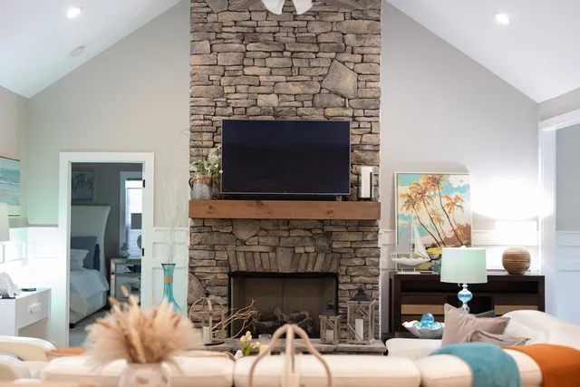 a living room with fireplace furniture and a wooden floor