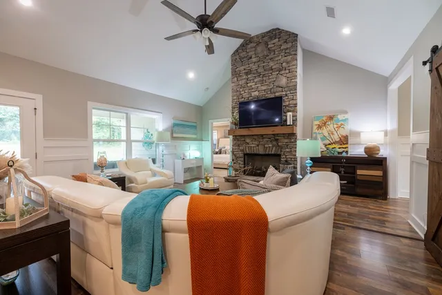 a living room with furniture and kitchen view