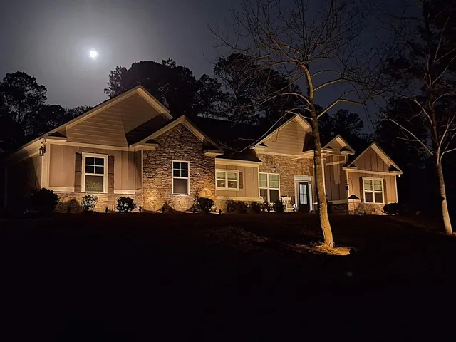 a front view of a house with a garden