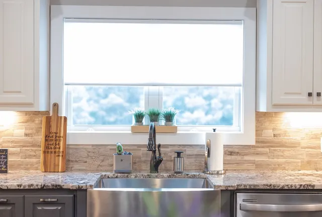 a kitchen with stainless steel appliances granite countertop a sink and cabinets