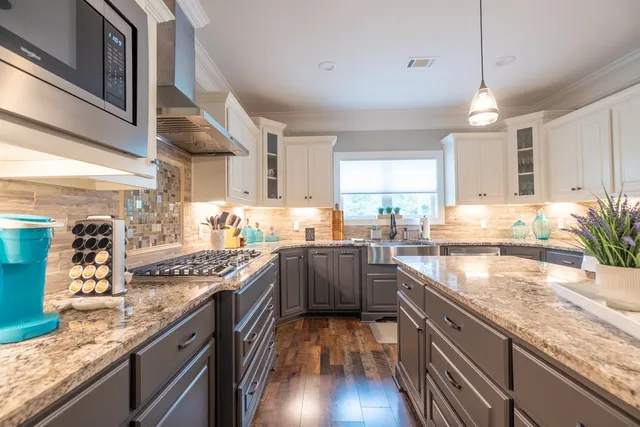 a bedroom with a balcony a bed and a chandelier