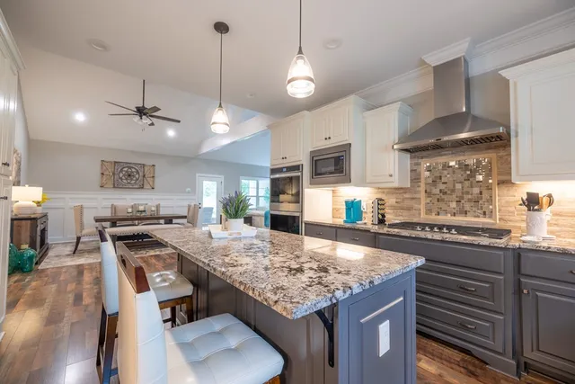 a spacious bedroom with a bed a couch and a flat screen tv