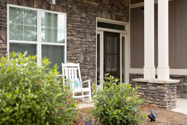 a front view of a house with a yard tree s