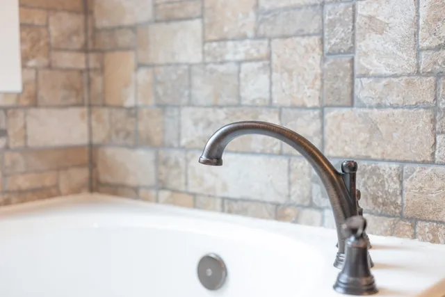 a bathroom with a granite countertop toilet sink and mirror
