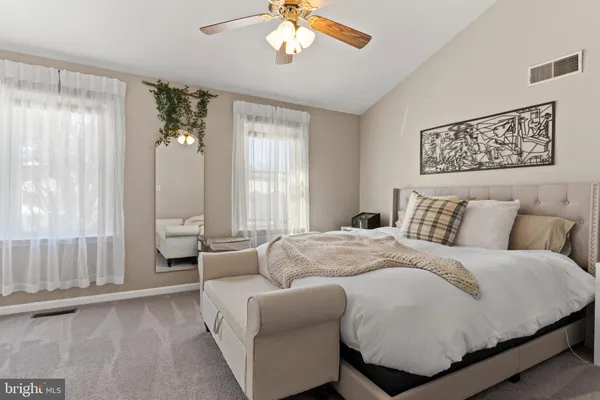 a spacious bedroom with a bed and a couch