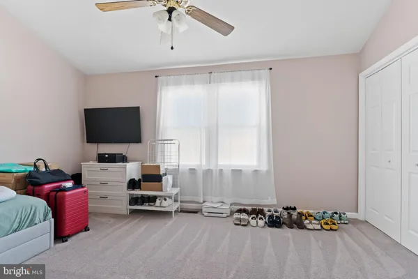 a bedroom with furniture and a flat screen tv