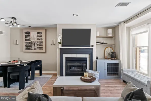 a living room with furniture fireplace and window