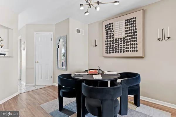 a dining room with furniture and wooden floor