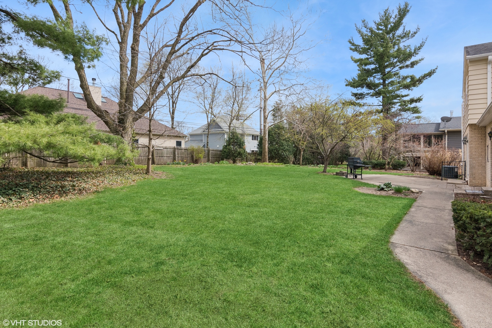 429 Grant Avenue Geneva, IL 60134 - Photo 29 of 34 a backyard of a house with large trees and outdoor seating