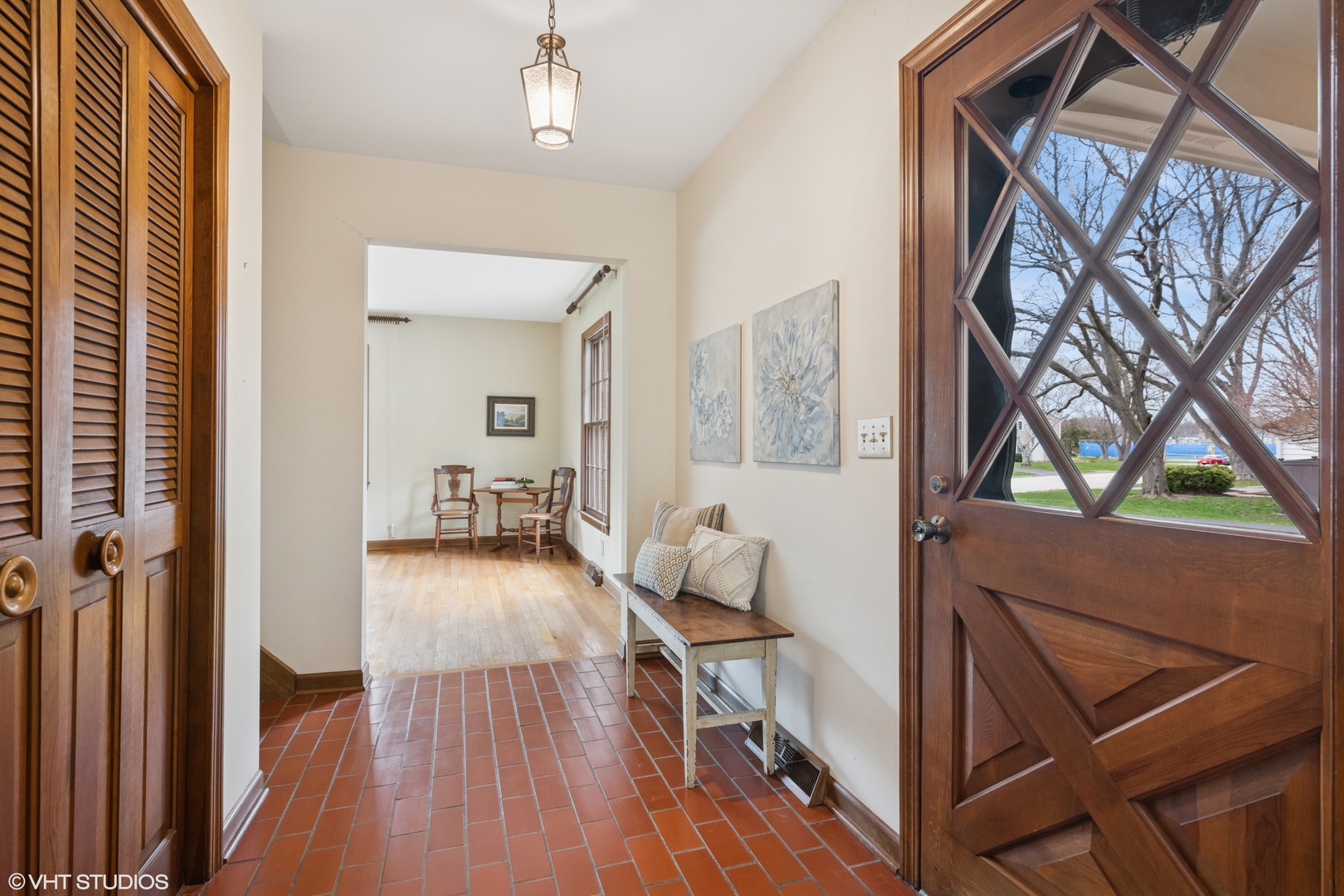 429 Grant Avenue Geneva, IL 60134 - Photo 4 of 34 a view of a hallway to a livingroom with wooden floor and furniture