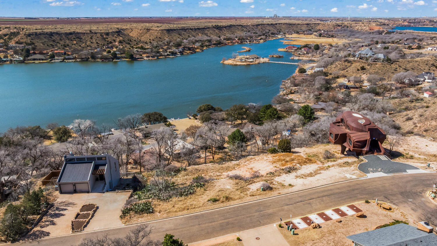 87 East Canyonview Drive Ransom Canyon, TX 79366 - Photo 2 of 42 an aerial view of a house with a lake view