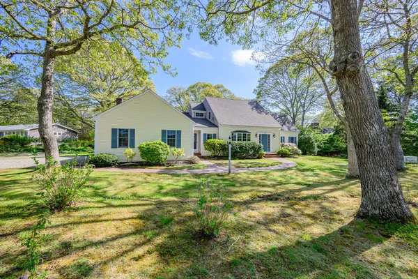 a front view of house with yard and green space