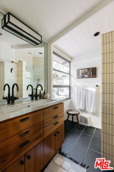 2044 Mayview Drive Los Angeles, CA 90027 - Photo 24 of 44 a spacious bathroom with a double vanity sink a mirror and a shower