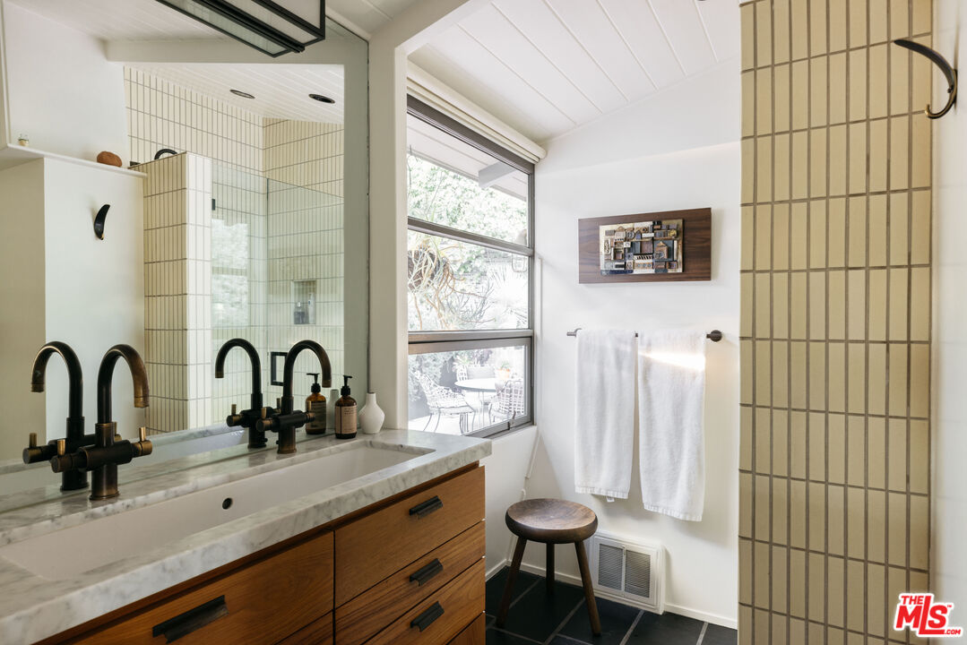 2044 Mayview Drive Los Angeles, CA 90027 - Photo 25 of 44 a bathroom with a sink and a large mirror