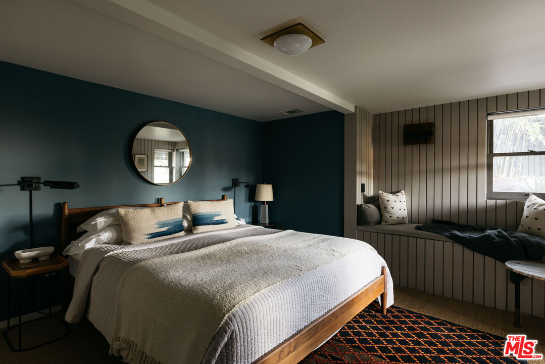 2044 Mayview Drive Los Angeles, CA 90027 - Photo 31 of 44 a bedroom with bed and a chandelier