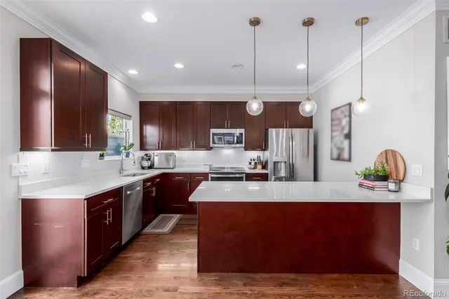 a large kitchen with stainless steel appliances kitchen island granite countertop a stove a sink and a granite counter tops