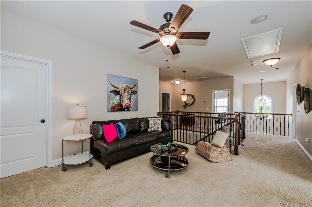 651 Quicksilver Trail Fort Mill, SC 29708 - Photo 20 of 37 a living room with furniture ceiling fan and a rug
