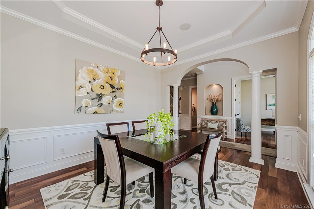 651 Quicksilver Trail Fort Mill, SC 29708 - Photo 6 of 37 a view of a dining room with furniture wooden floor and a chandelier