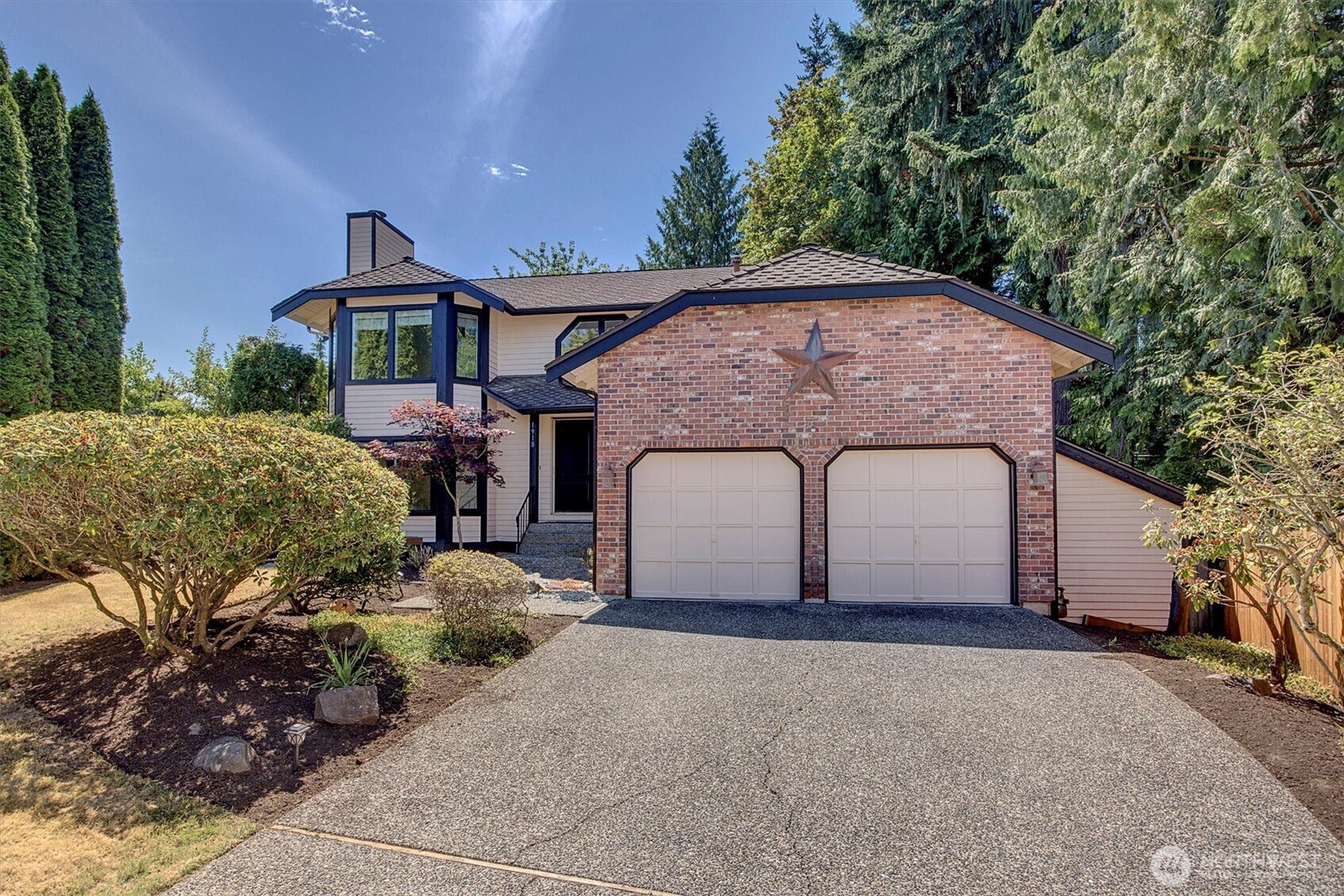 1918 238th Street Southeast Bothell, WA 98021 - Photo 1 of 36 a front view of a house with a yard and garage