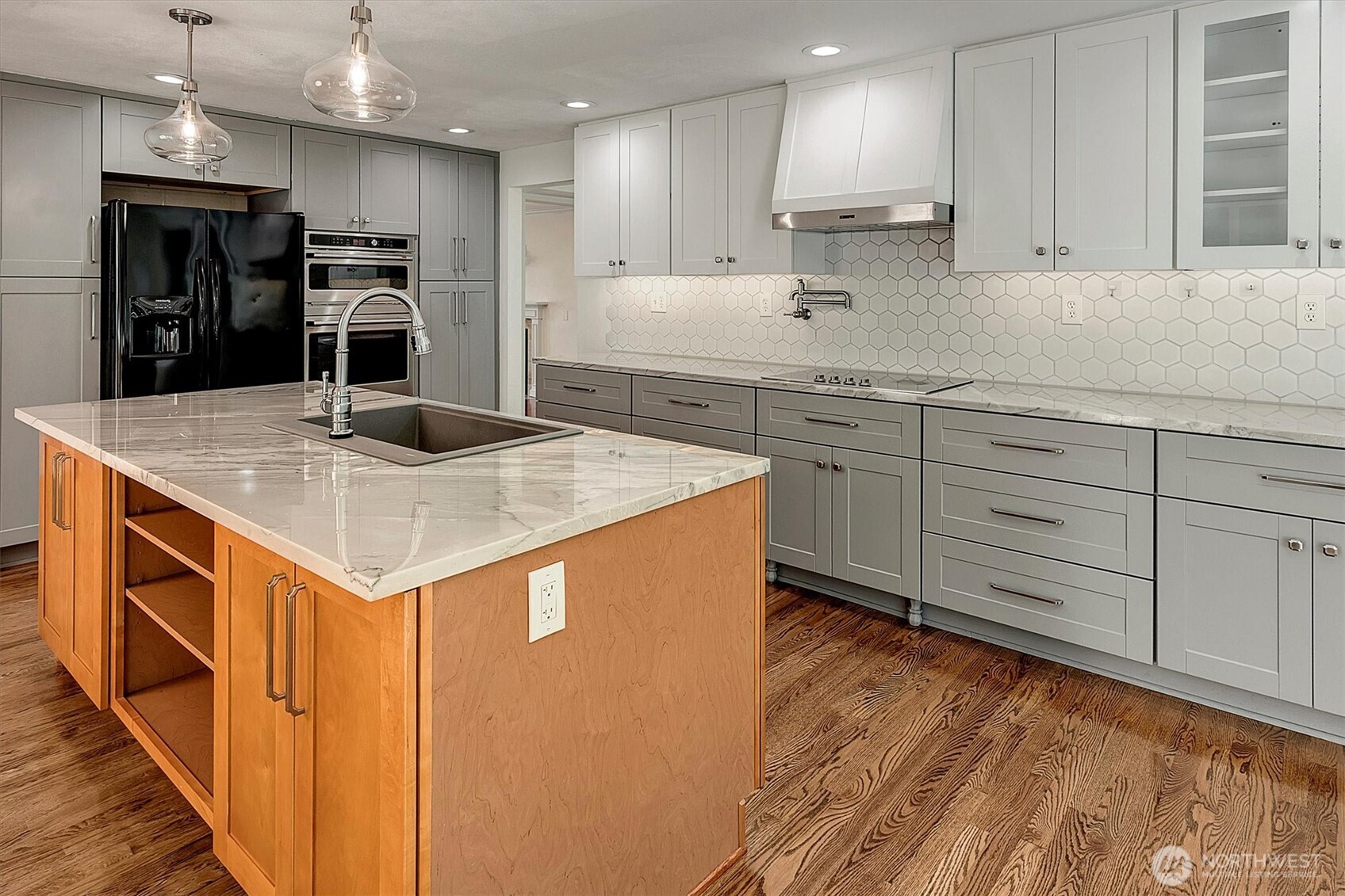 1918 238th Street Southeast Bothell, WA 98021 - Photo 12 of 36 a kitchen that has a lot of cabinets in it and wooden floors