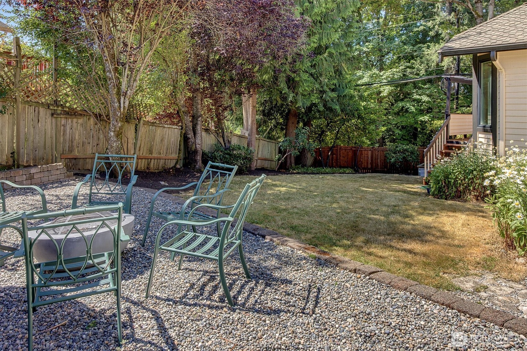 1918 238th Street Southeast Bothell, WA 98021 - Photo 29 of 36 a view of backyard with table and chairs and wooden fence