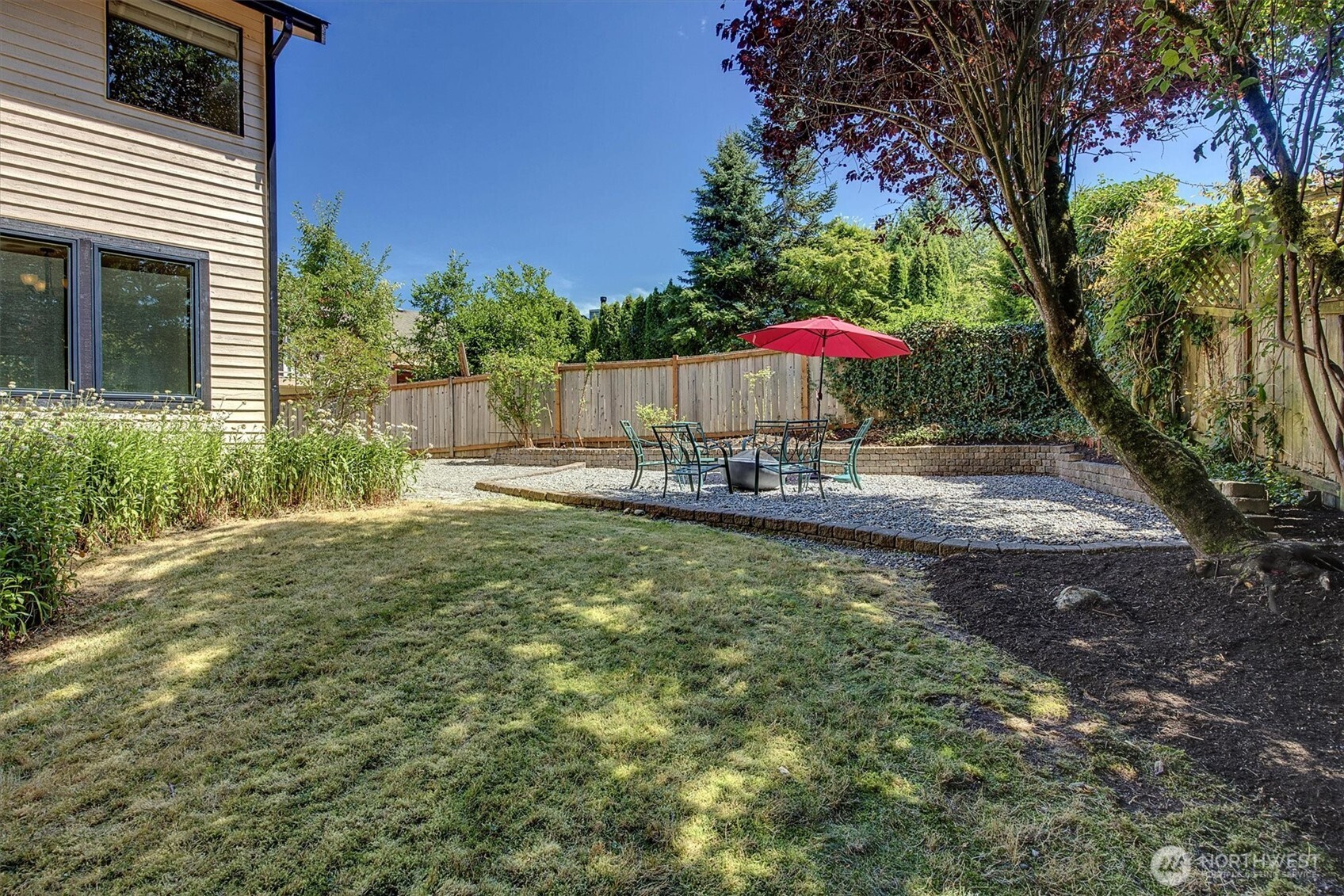 1918 238th Street Southeast Bothell, WA 98021 - Photo 30 of 36 a view of a backyard with a table and chairs under an umbrella