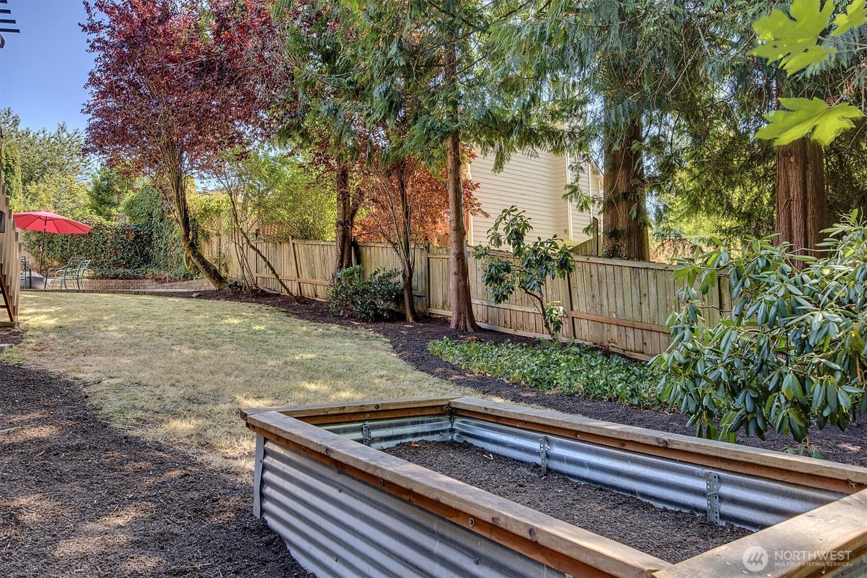 1918 238th Street Southeast Bothell, WA 98021 - Photo 33 of 36 a view of backyard with wooden fence and trees