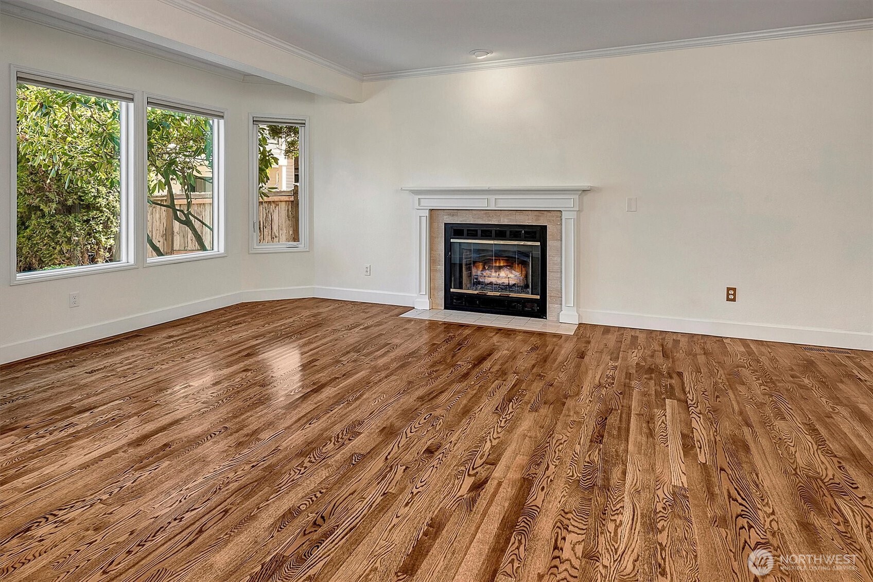 1918 238th Street Southeast Bothell, WA 98021 - Photo 4 of 36 an empty room with wooden floor a fireplace and windows