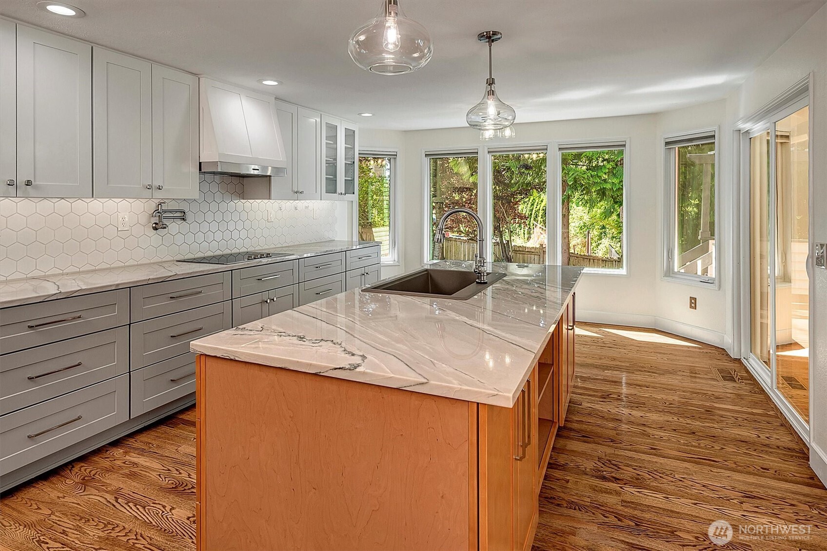 1918 238th Street Southeast Bothell, WA 98021 - Photo 10 of 36 a kitchen with kitchen island a large counter top space appliances and a center island