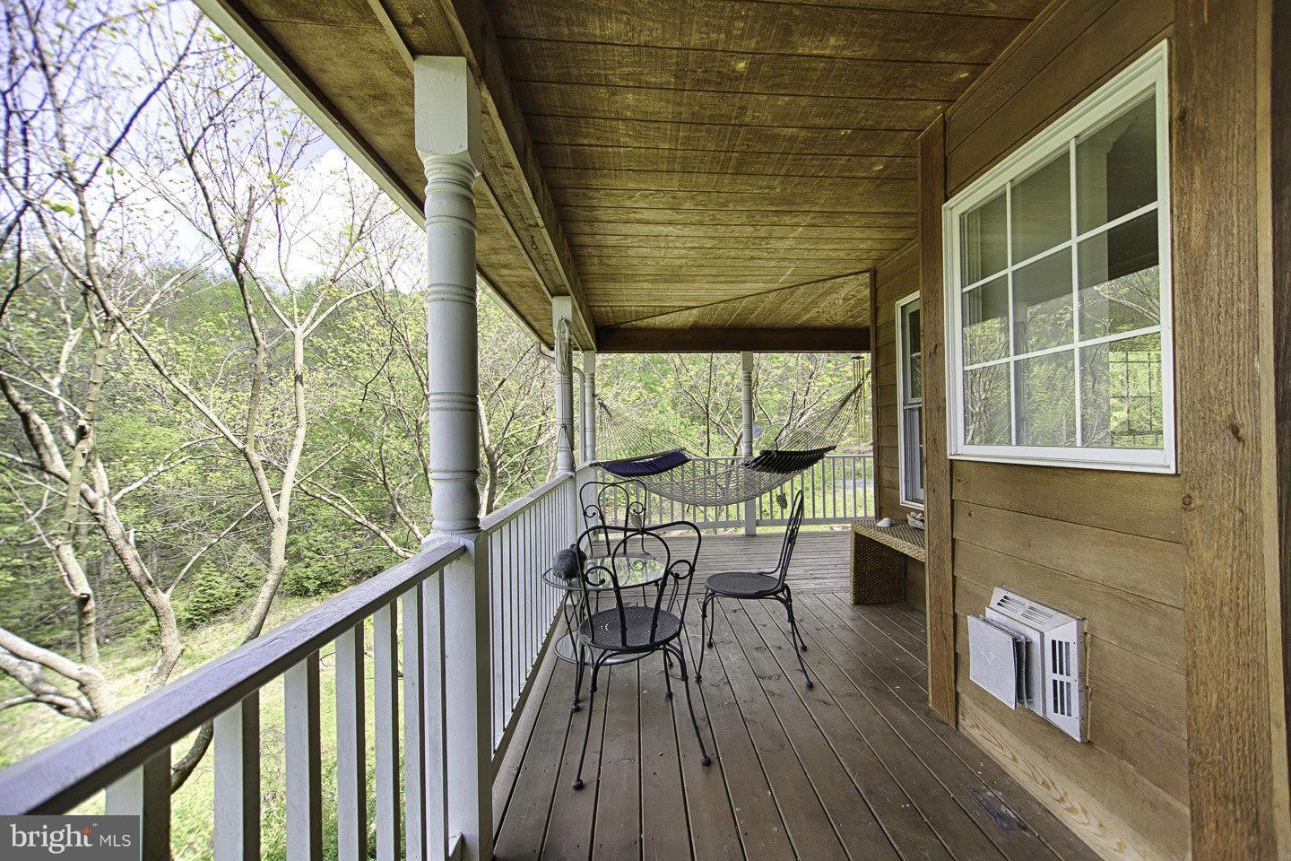 930 Pomeroy Road Front Royal, VA 22630 - Photo 3 of 30 a balcony with wooden floor and outdoor seating