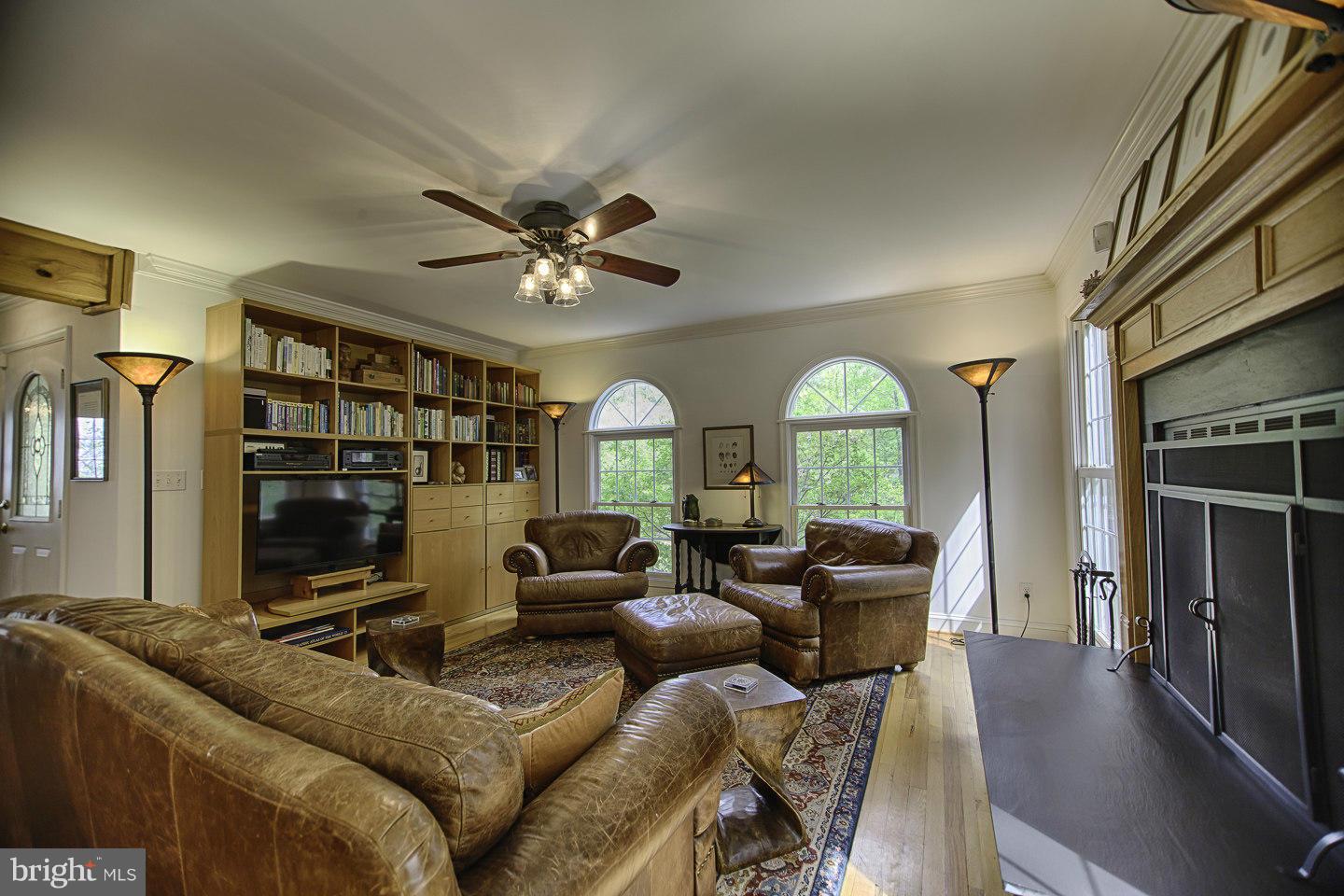 930 Pomeroy Road Front Royal, VA 22630 - Photo 8 of 30 a living room with furniture a fireplace and a flat screen tv