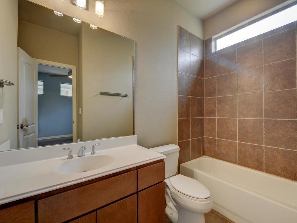 1115 Kinney Avenue, Unit 41 Austin, TX 78704 - Photo 14 of 26 a bathroom with a sink a toilet and shower