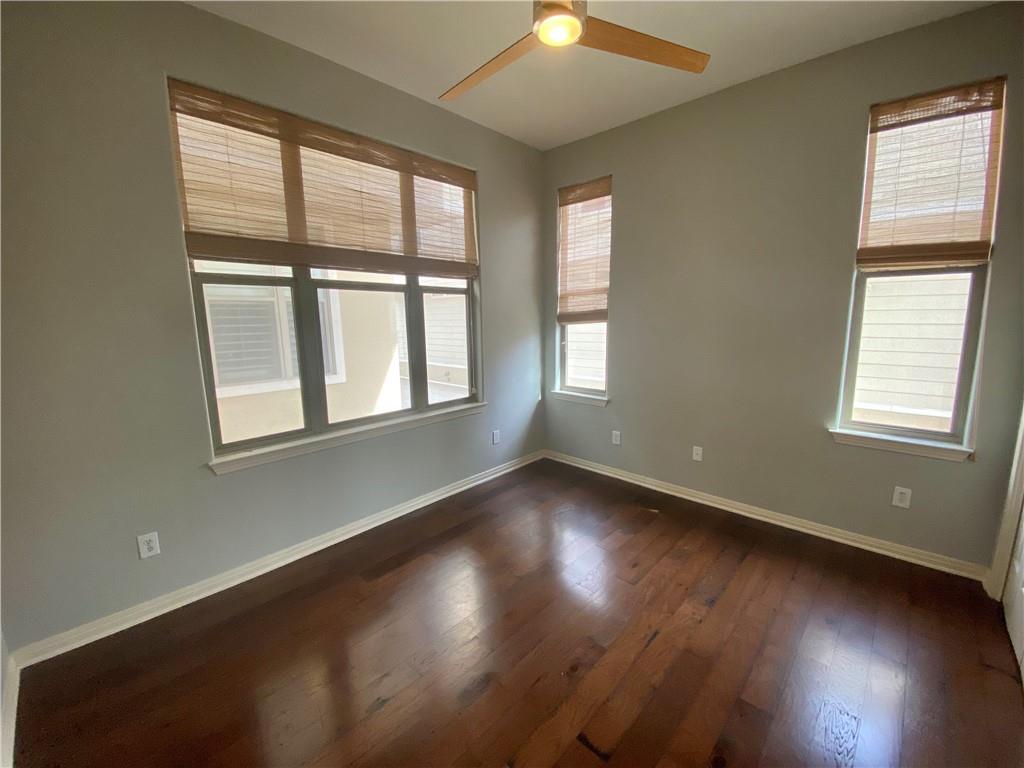 1115 Kinney Avenue, Unit 41 Austin, TX 78704 - Photo 15 of 26 a view of an empty room with wooden floor and a window