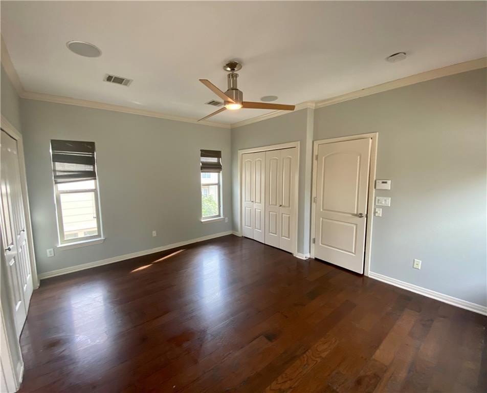 1115 Kinney Avenue, Unit 41 Austin, TX 78704 - Photo 17 of 26 a view of an empty room with wooden floor and a window