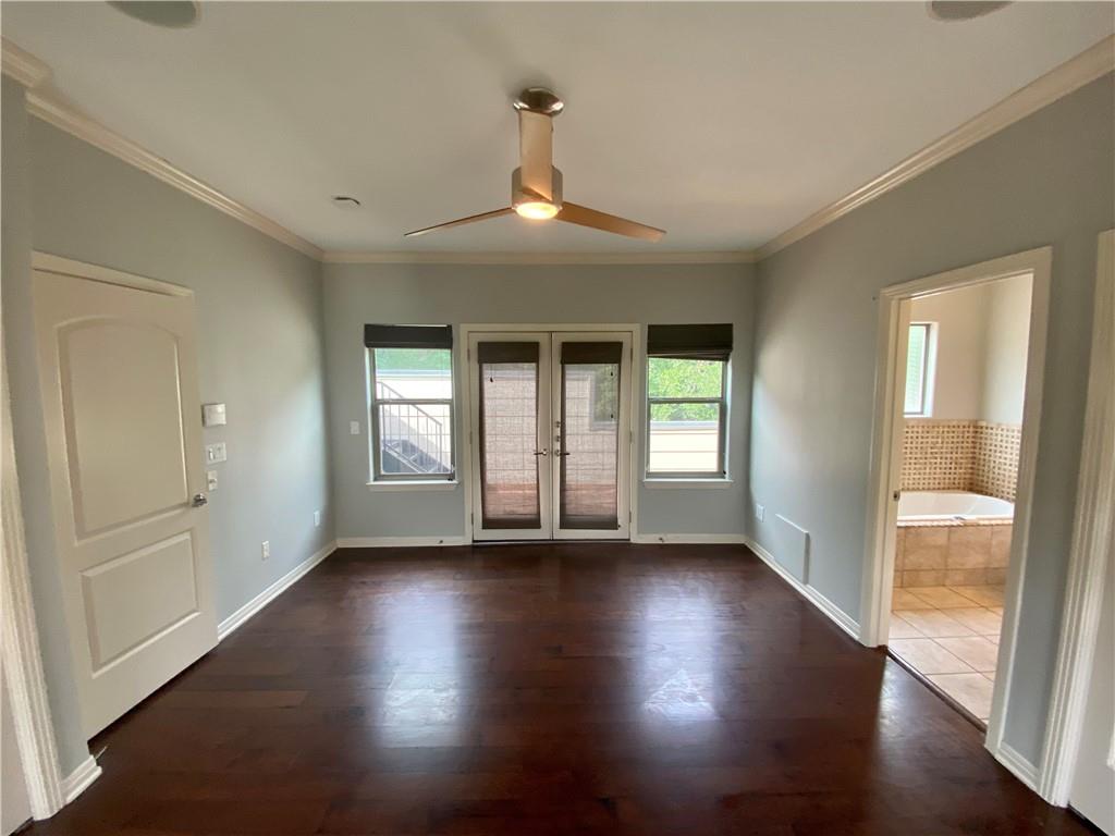 1115 Kinney Avenue, Unit 41 Austin, TX 78704 - Photo 18 of 26 an empty room with wooden floor and windows