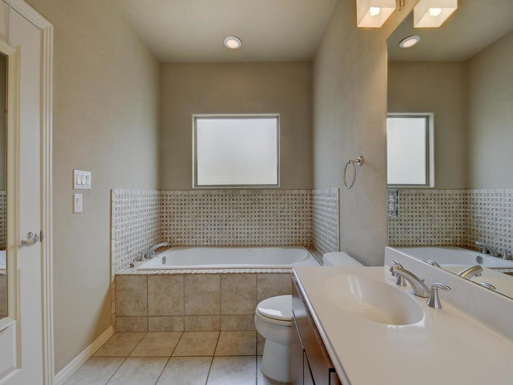 1115 Kinney Avenue, Unit 41 Austin, TX 78704 - Photo 19 of 26 a bathroom with a sink a toilet and shower