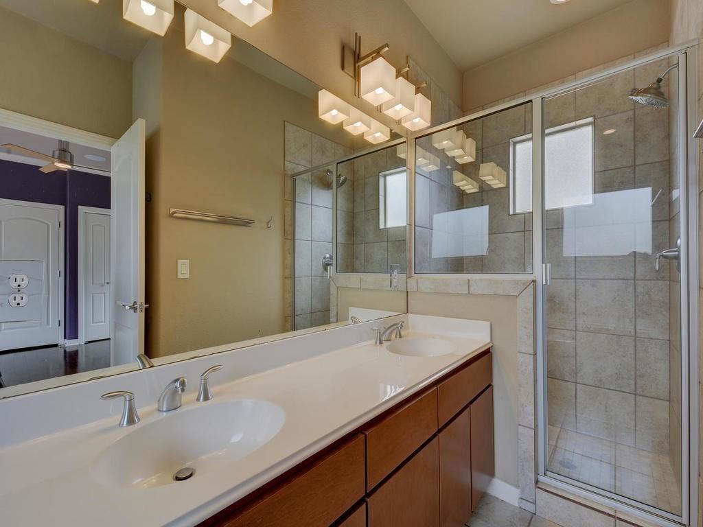 1115 Kinney Avenue, Unit 41 Austin, TX 78704 - Photo 20 of 26 a bathroom with a sink vanity granite and shower