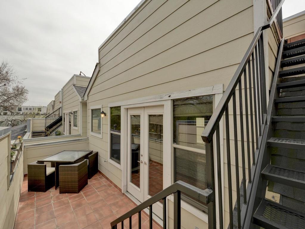 1115 Kinney Avenue, Unit 41 Austin, TX 78704 - Photo 23 of 26 a view of a porch with wooden floor and iron stairs