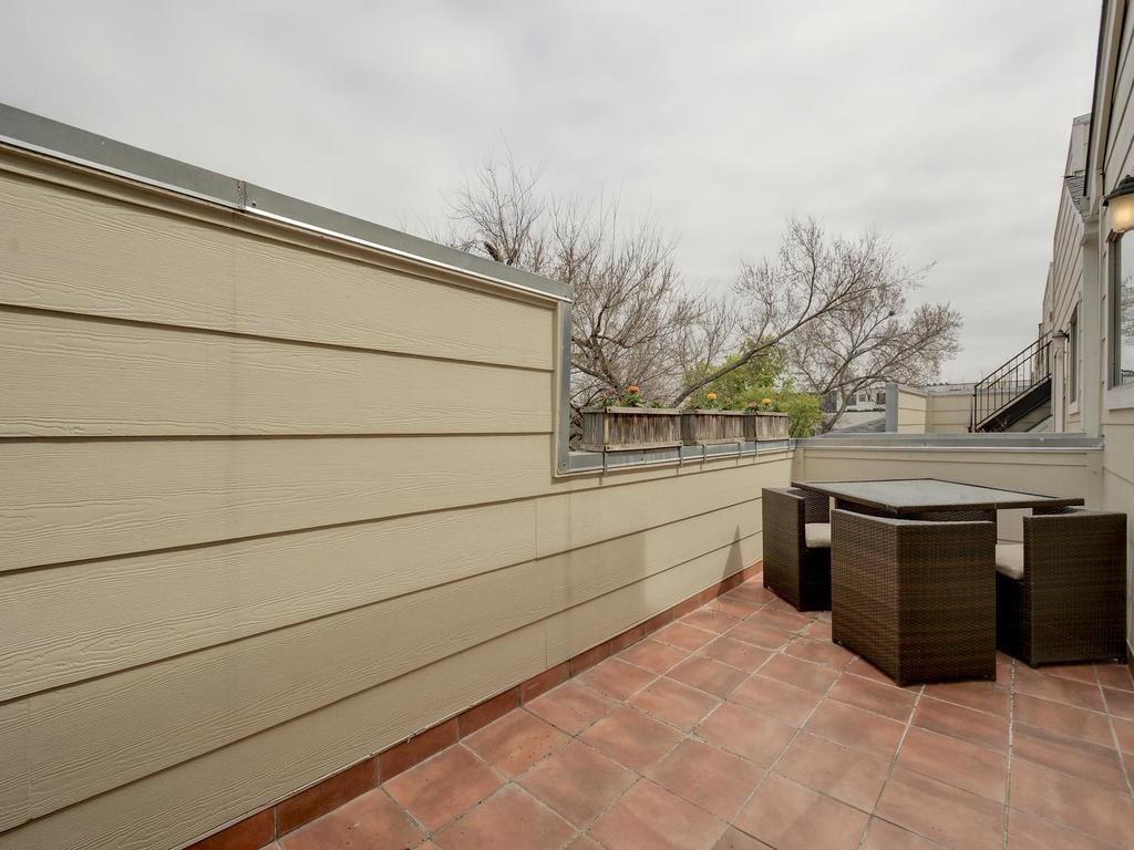 1115 Kinney Avenue, Unit 41 Austin, TX 78704 - Photo 25 of 26 a room with trees and dryer on the wall
