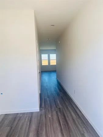 a view of wooden floor and windows in a room