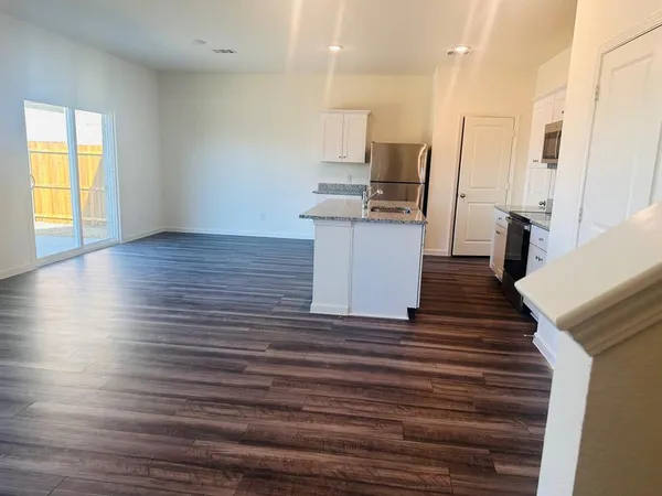 a view of kitchen and wooden floor
