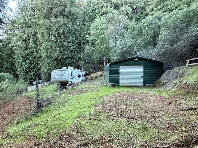 7175 Redwood Retreat Road Gilroy, CA 95020 - Photo 12 of 46 a backyard of a house with a garden and barbeque oven