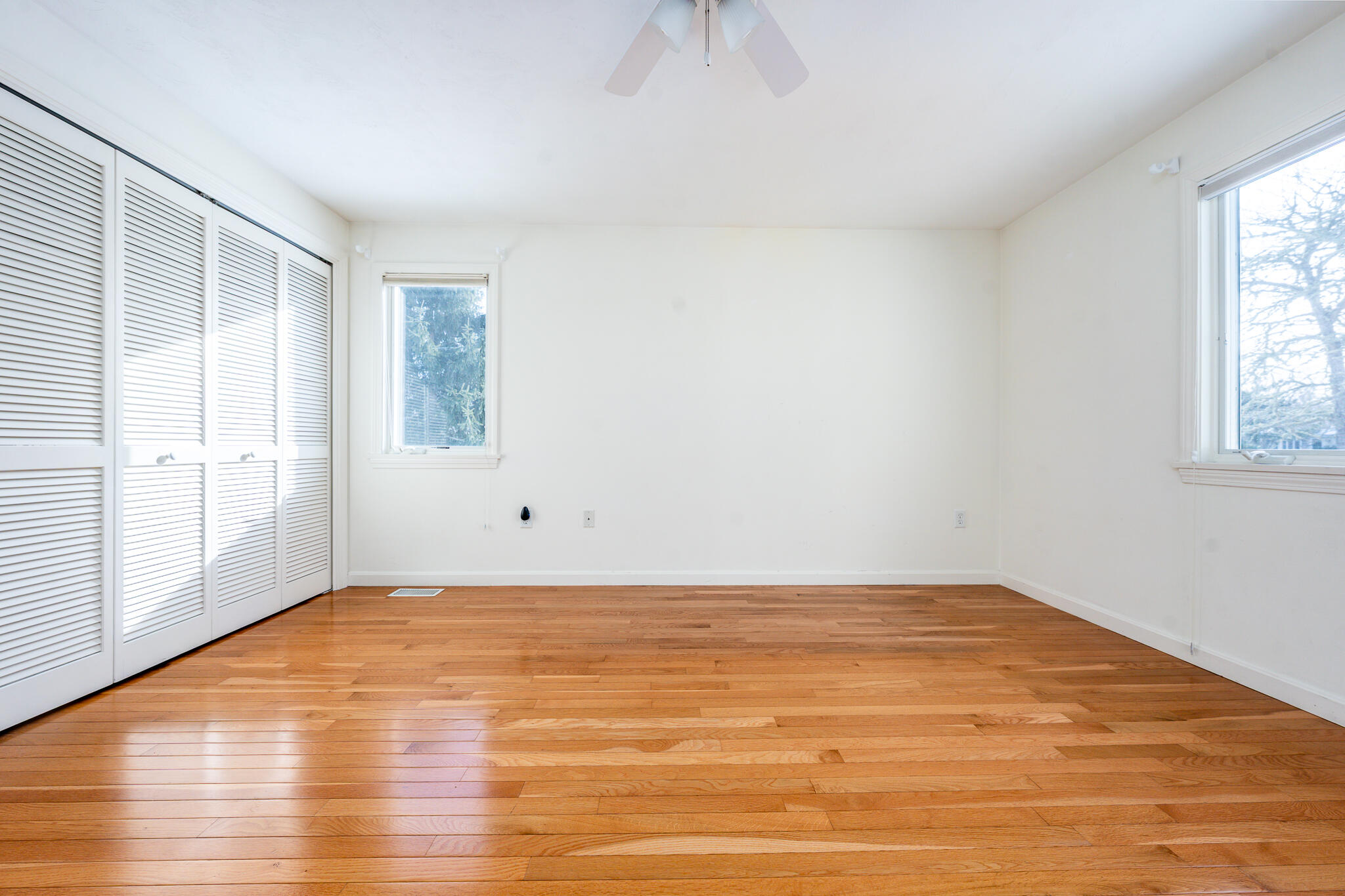 1 Masters Court Mashpee, MA 02649 - Photo 13 of 32 an empty room with wooden floor and windows