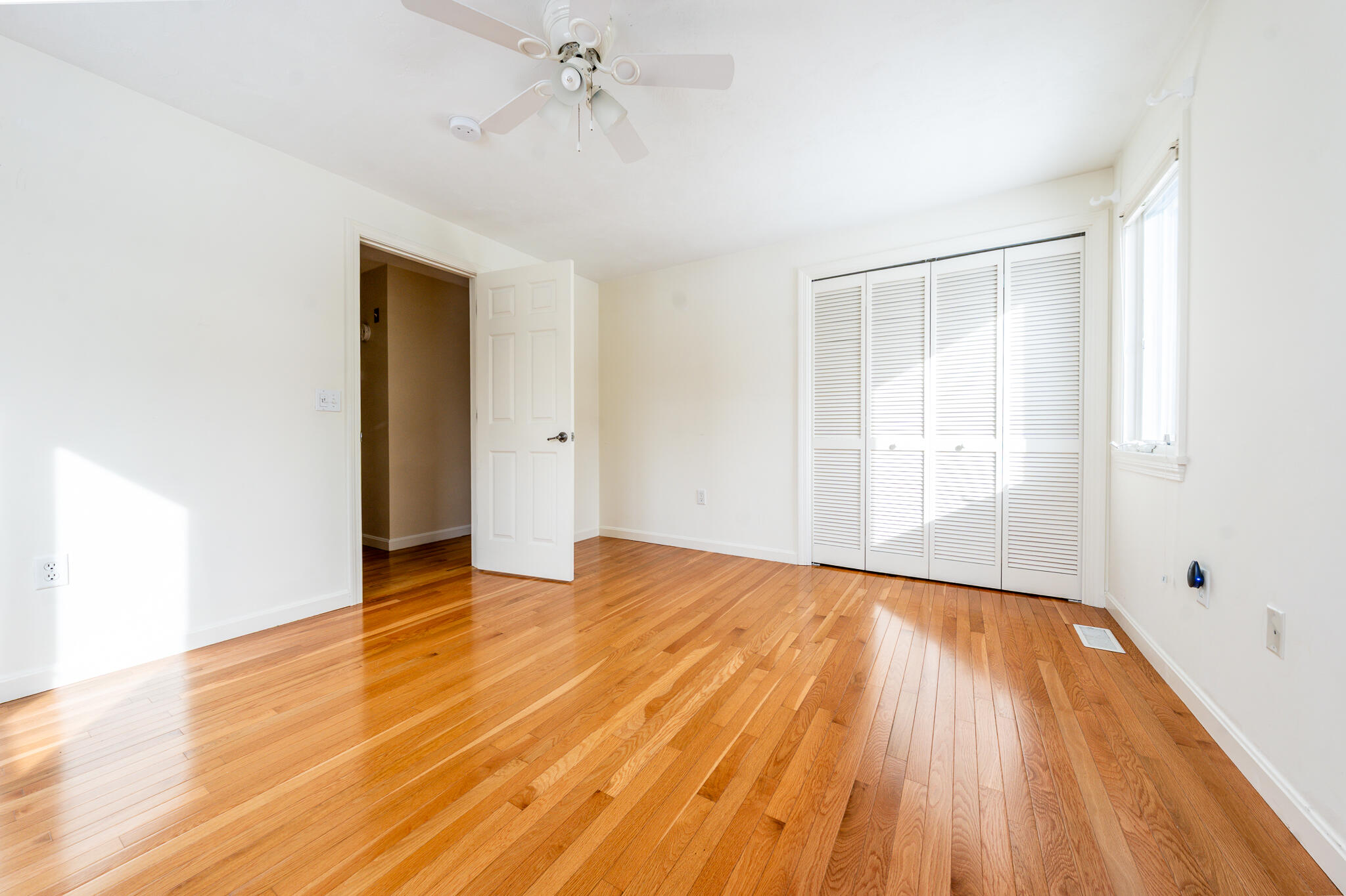 1 Masters Court Mashpee, MA 02649 - Photo 14 of 32 a view of an empty room with wooden floor and a window