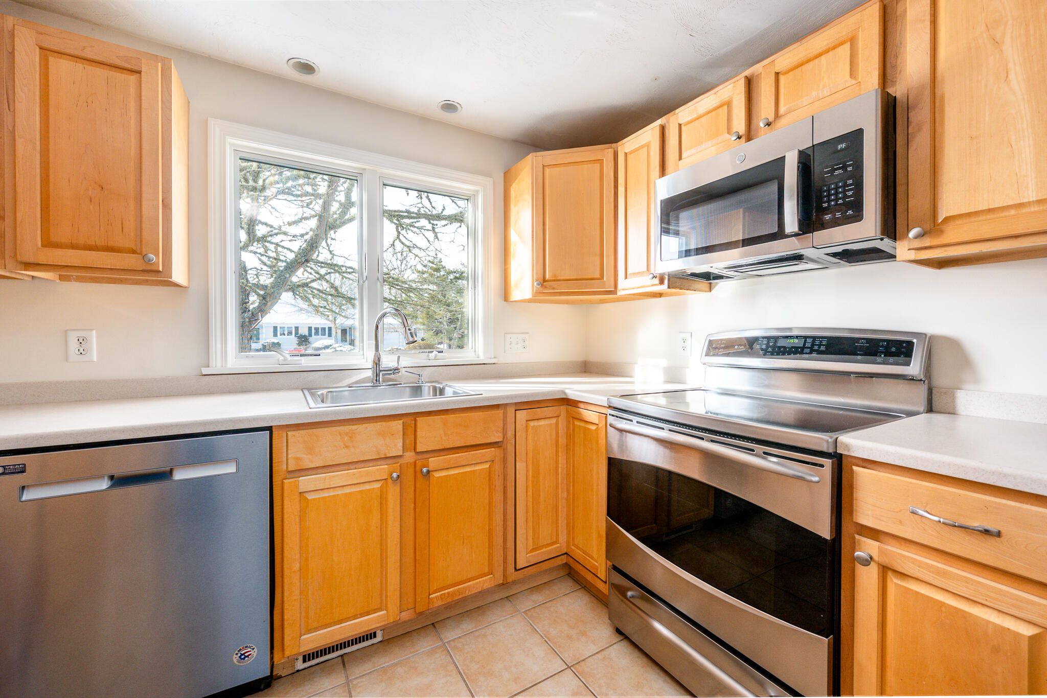1 Masters Court Mashpee, MA 02649 - Photo 7 of 32 a kitchen with stainless steel appliances granite countertop white cabinets a window and a sink