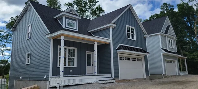a view of a house with a garage and balcony