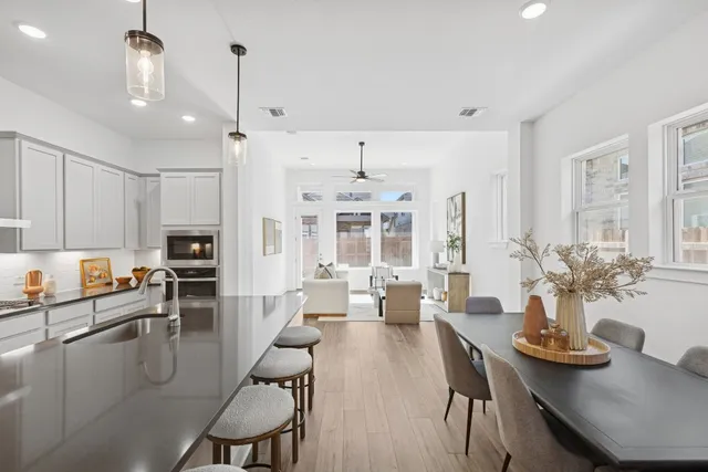 a very nice looking dining room with kitchen island furniture a chandelier and a view of kitchen